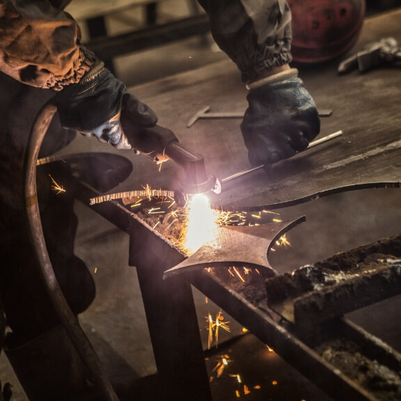 A man cutting some metal